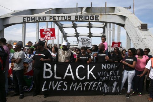 Marchers cross the Edmund Pettus Bridge in imitation of the 1965 "Bloody Sunday" march.